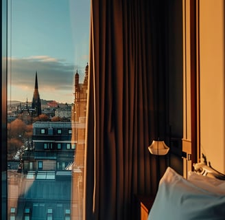 A bedroom with a view of a city skyline in glasgow