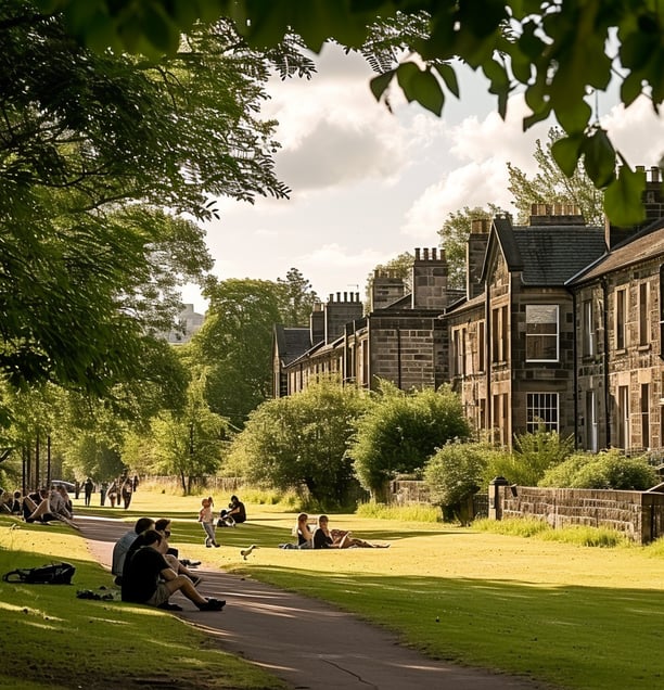 a group of people sitting on a path in a park in south glasgow