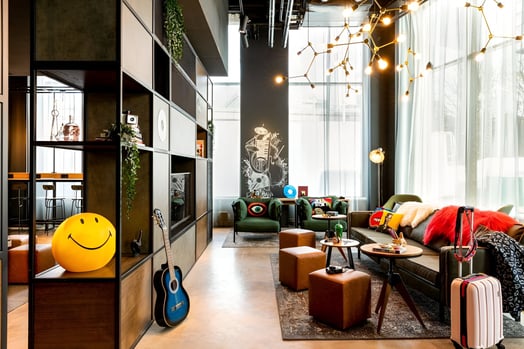 a living room with a couch and a guitar of a hotel in west end glasgow