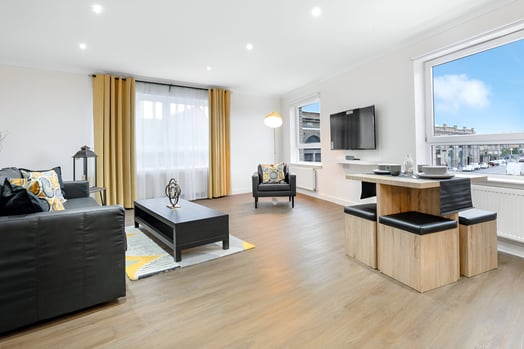 a living room with a couch and a television in southside glasgow