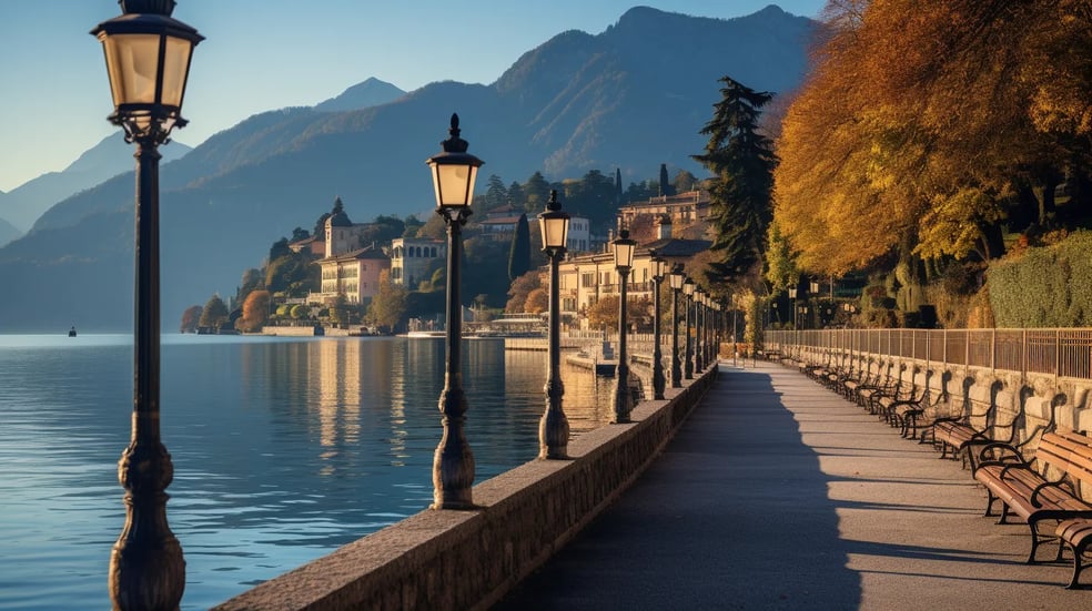 a row of street lamps along a path by the lake