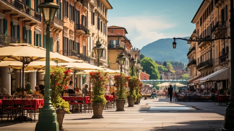 A street scene with a couple of tables and umbrellas