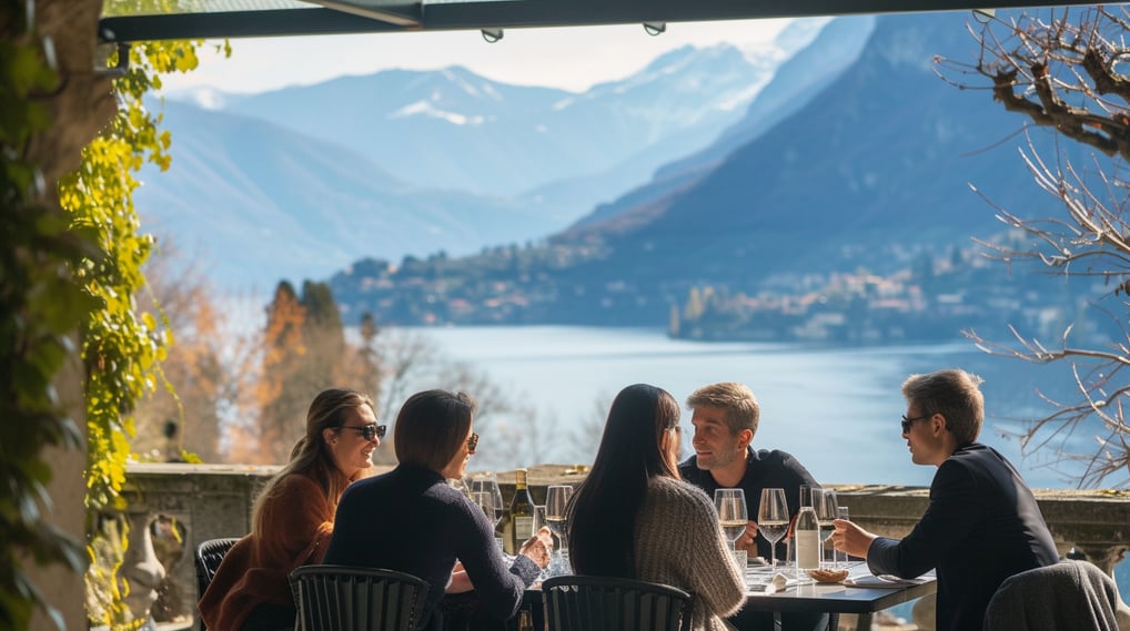 A group of people sitting at a table with wine glasses with lake como on the background