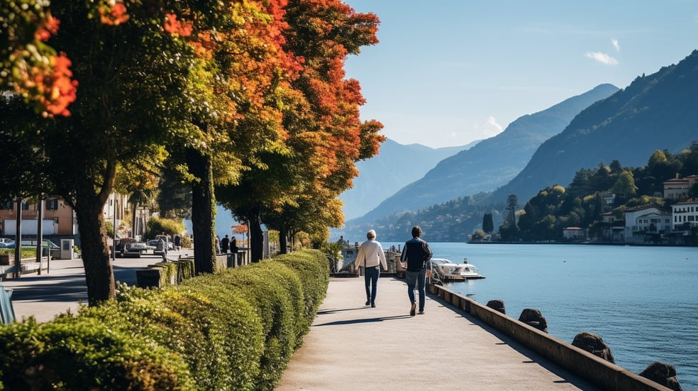 Two people walking along Cernobbio’s waterfront in Lake Como