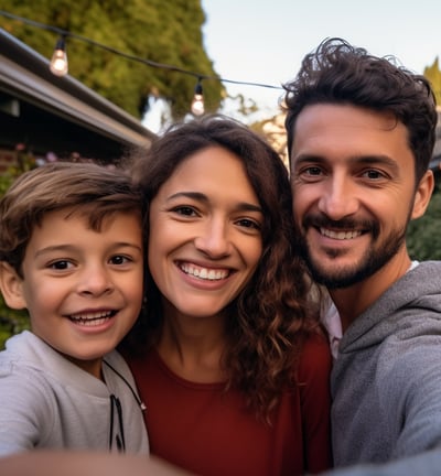 a man, woman, and child taking a selfie