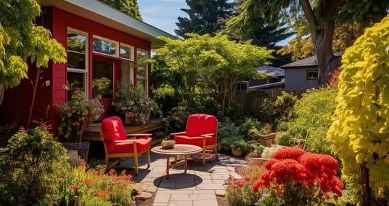 a patio with red chairs and a table