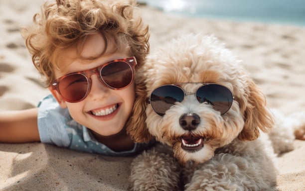 a young boy and his dog lying on the sands of Abaco Island's beaches