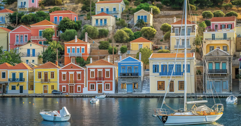 the colorful buildings by the port of Symi, Greece