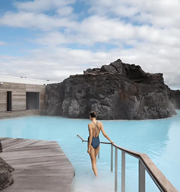 Woman in bathing suit strolling on wooden walkway in blue lagoon. Woman in bathing suit strolling on wooden walkway in blue lagoon.