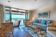 a living room with a couch and chairs a living room with a couch and chairs