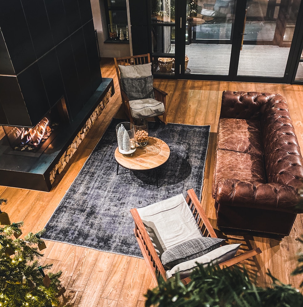 Brown leather couch beside brown wooden table
