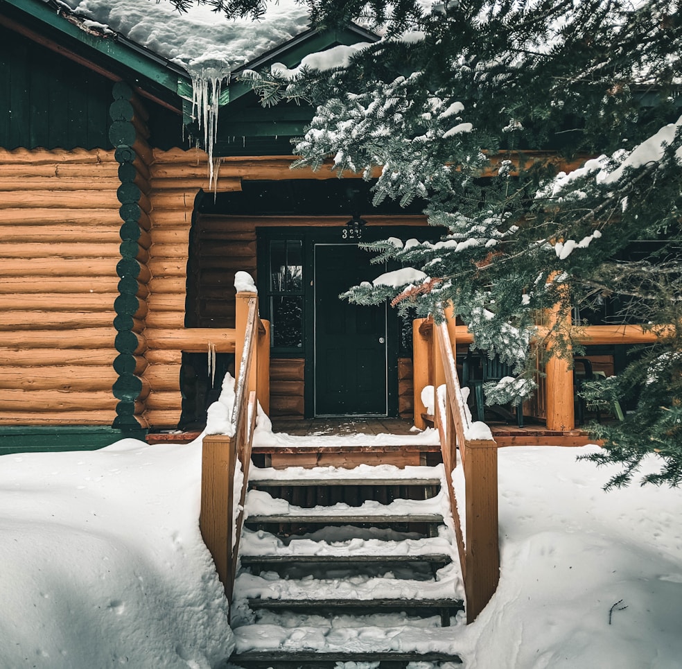 Brown wooden staircase covered with snow