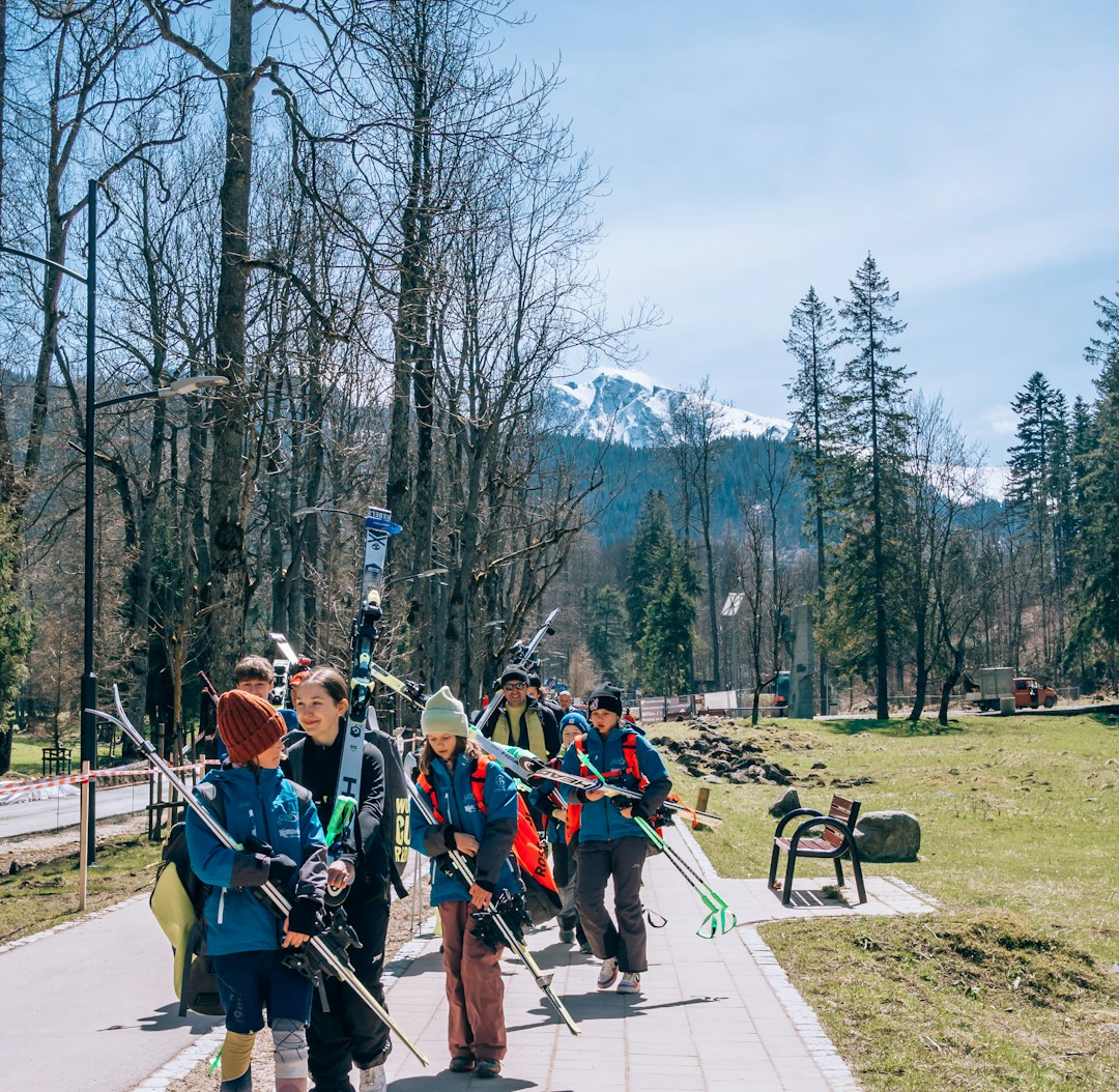 a group of people walking down a sidewalk