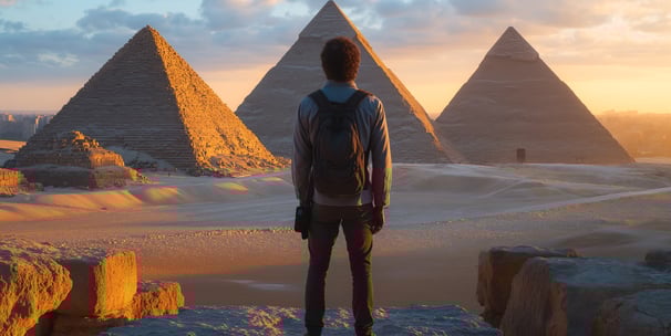 a man standing in front of pyramids in Egypt a man standing in front of pyramids in Egypt