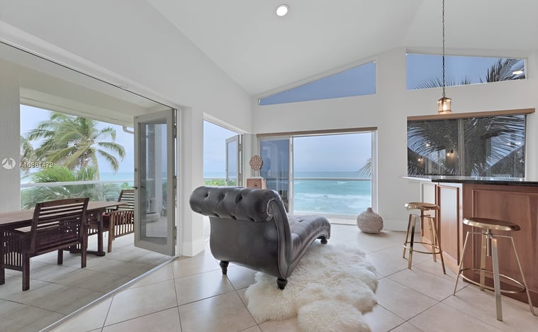 A living room with a couch and a table with the view of hollywood beach, florida A living room with a couch and a table with the view of hollywood beach, florida