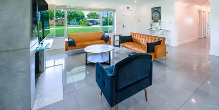 A living room with a couch and a television in hollywood beach, florida A living room with a couch and a television in hollywood beach, florida