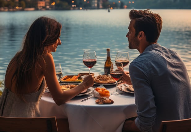 photo of couple eating with lake view