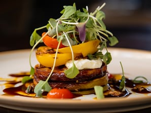 a plate of food with vegetables and sauce