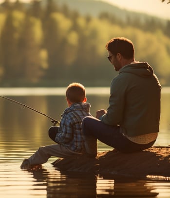 a man and a boy fishing by the lake