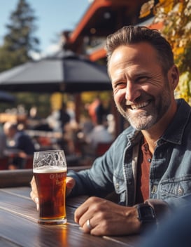 photo of man smiling and enjoying beer