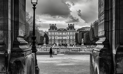 A female traveler is standing in front of an ancient building