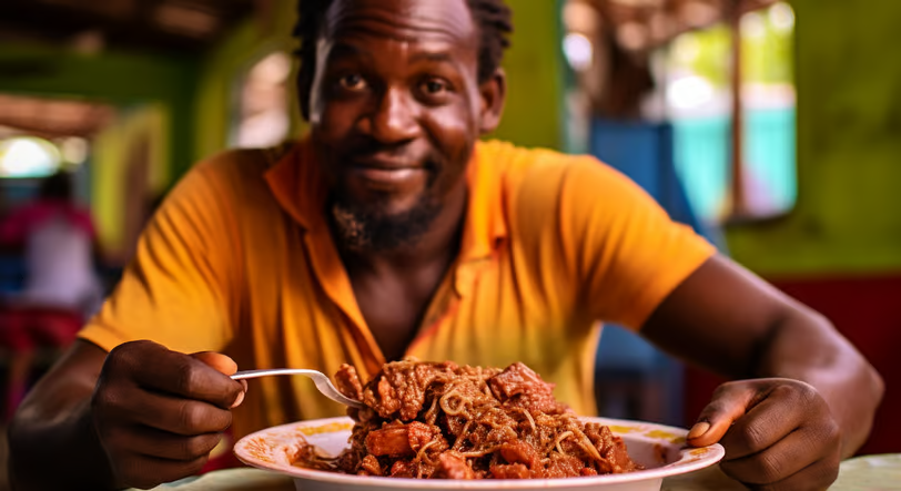 a man sitting at a table with a bowl of food a man sitting at a table with a bowl of food