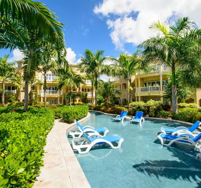 a pool with lounge chairs a pool with lounge chairs