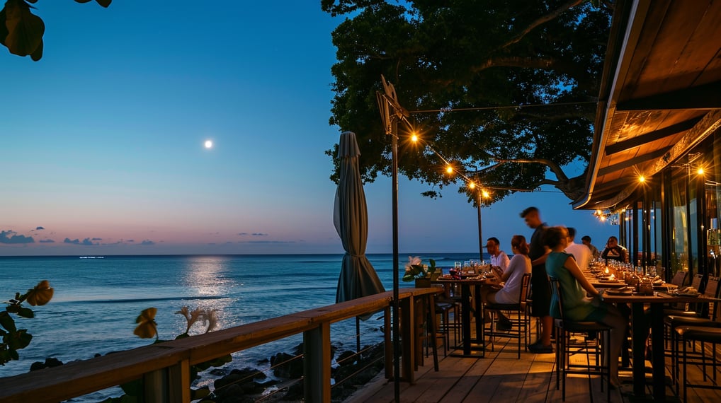 A picturesque beach restaurant at sunset, with vibrant colors illuminating the sky and reflecting on the tranquil ocean waves.