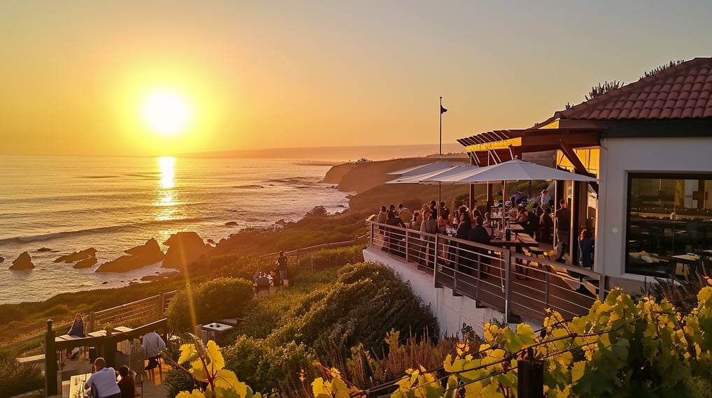 A breathtaking sunset over the ocean with a restaurant in the background.