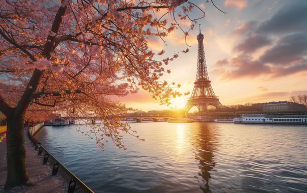 The Eiffel Tower in Paris, France, illuminated by the warm hues of sunset, creating a picturesque evening scene