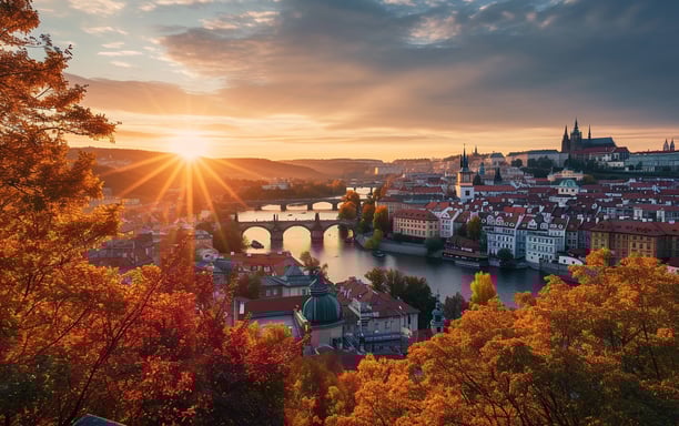 The sun rises over Prague's autumn skyline
