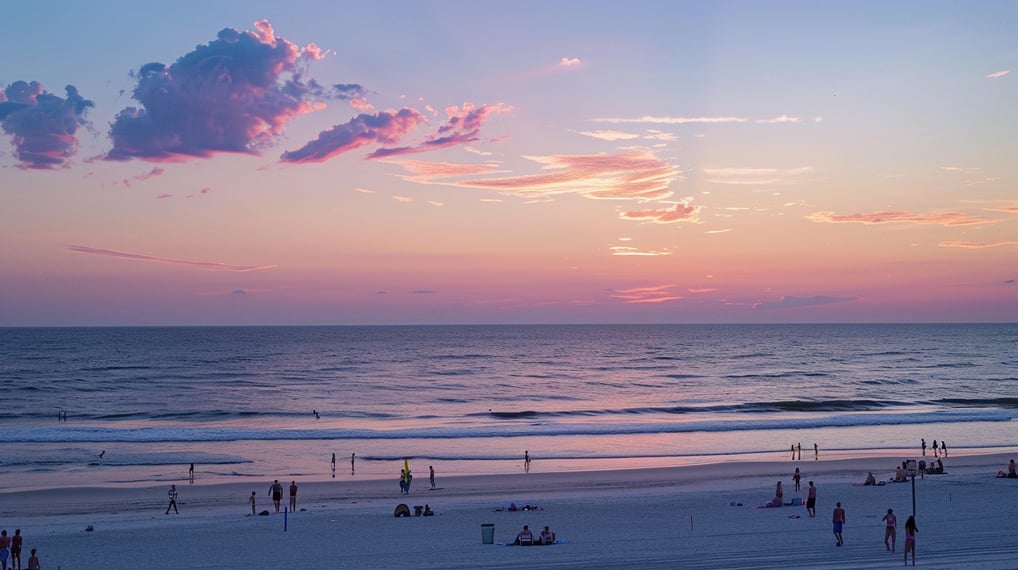 a beach with people on it during sunset