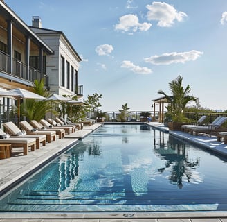 A pool with lounge chairs and umbrellas of a hotel in long island, new york