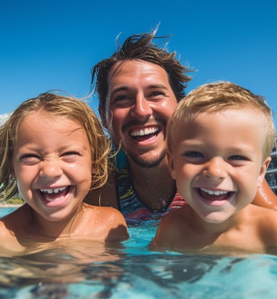 a man and two children in a swimming pool
