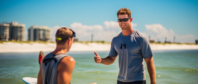 a man in a gray shirt standing in the water