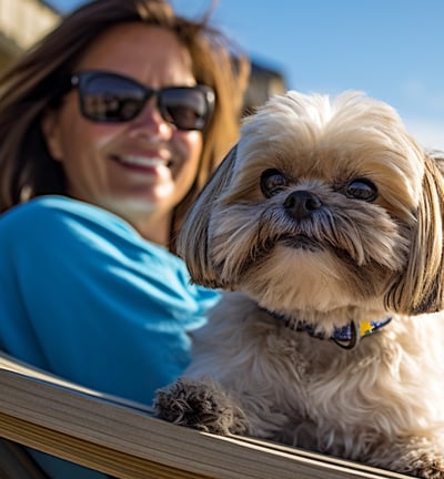 a woman sitting in a chair with a dog
