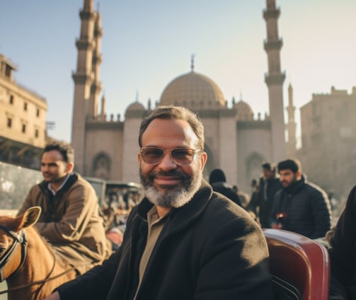 A man with a beard sitting on a horse drawn carriage