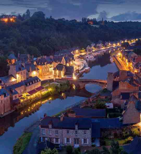 aerial photography of lighted concrete buildings at night time aerial photography of lighted concrete buildings at night time