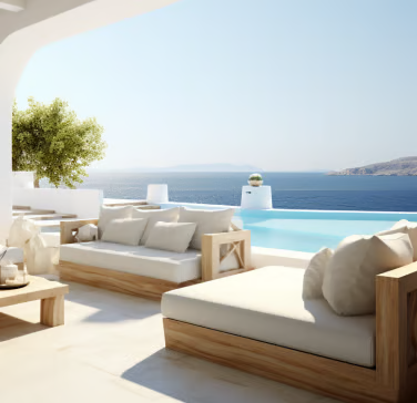 a patio with a couch and a table overlooking the ocean a patio with a couch and a table overlooking the ocean