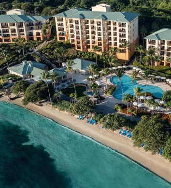 A hotel with a view of the ocean and a beach A hotel with a view of the ocean and a beach