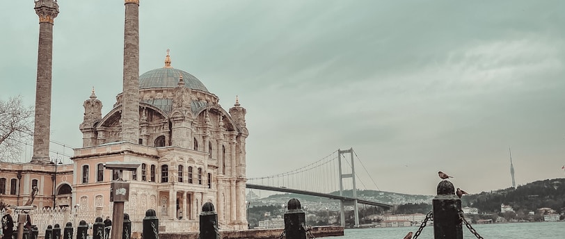 people sitting on beach shore near brown concrete building during daytime