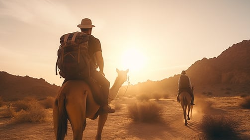 A tourist and his guide riding camelback on Thar Desert in India.
