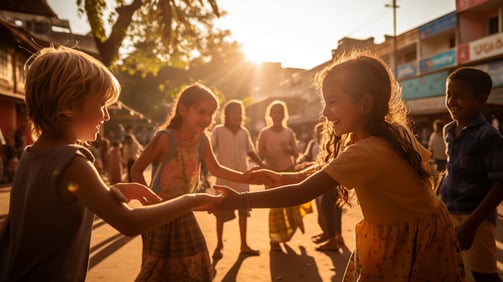 Tourist kids playing with the local children of India on the street.