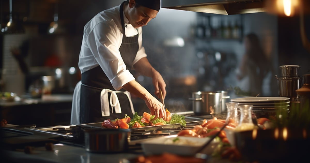 a chef in a restaurant preparing food a chef in a restaurant preparing food