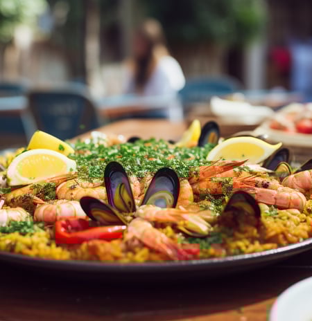 a large pan of food with seafood and rice