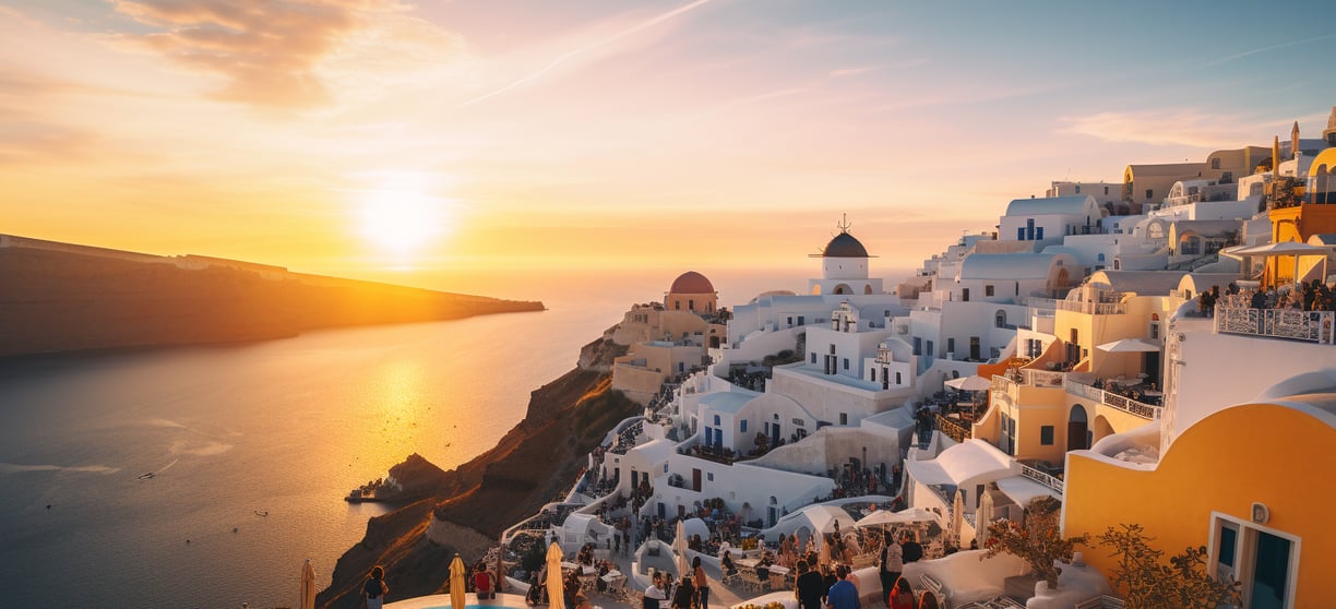 white-washed buildings beside the sea during sunset