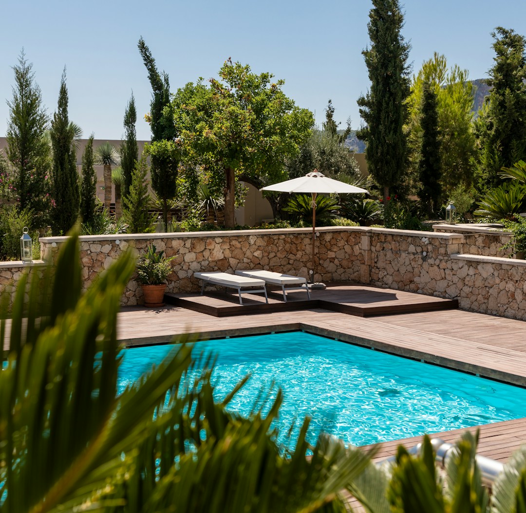 White umbrella by the swimming pool White umbrella by the swimming pool