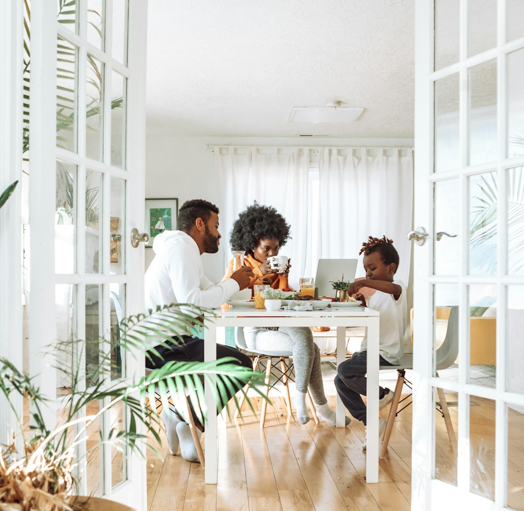 People sitting on chairs in front of table People sitting on chairs in front of table