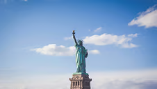 Statue of Liberty in front of a blue sky