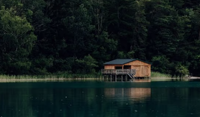 brown wooden house on lake brown wooden house on lake